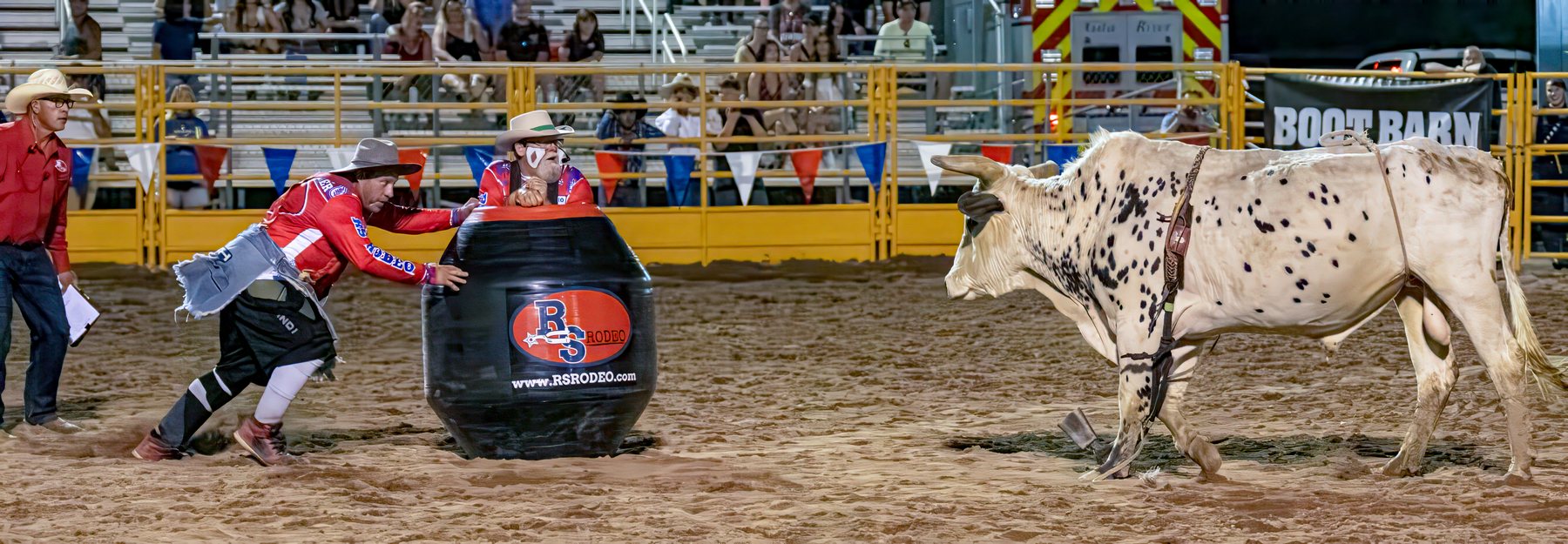 RS Rodeo bullfighters and barrelman working a bull in the arena